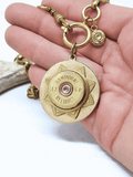 12 Gauge Hawthorne Reliance Brand Vintage Brass Shotshell Necklace held in hand for scale