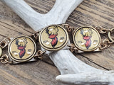 Detailed view of vintage gold buck head bottle cap riveted into handcrafted brass bracelet link