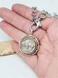 A buffalo nickel medallion on a gold paper clip chain necklace being held in a hand to show close up and scale.