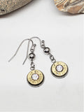 Bullet casing earrings with crystal stones on a light background
