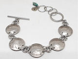 buffalo nickel coin bracelet with toggle clasp on white background.