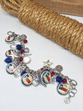 Texas patriotic charm bracelet laid flat with vintage Texas flag pinbacks, crystals, stars, red and blue beads and SureShot logo charm