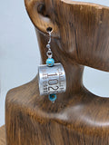 Single goose band dangle earring shown on wooden ear jewelry display, demonstrating the lightweight profile, turquoise bead accents and size when hanging.