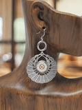 The image shows a pair of antique silver round basketweave earrings with a 45 auto bullet casing design, displayed on a wooden earring stand.